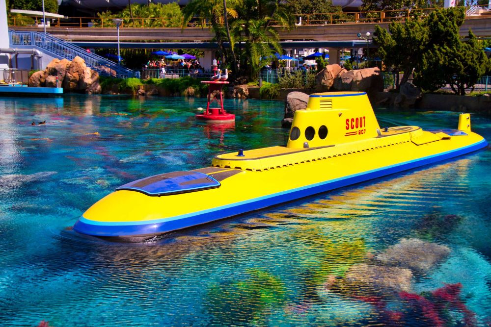 a garishly yellow submarine sits at the surface of the tomorrowland lagoon. its the finding nemo submarine voyage in disneyland.