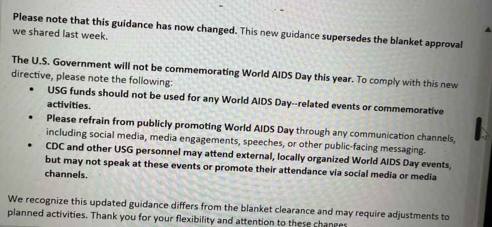 Photograph of a printed guidance memo stating that the U.S. Government will not be commemorating World AIDS Day this year. Key points include: USG funds should not be used for related events, personnel should refrain from public promotion via social media or other channels, and CDC and other USG staff may attend local events but cannot speak or promote attendance. The memo notes this guidance supersedes previous blanket approval and may require adjustments to planned activities.