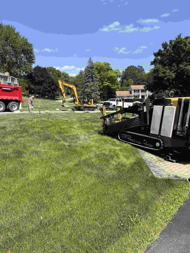 Construction equipment on a lawn and a residential street.