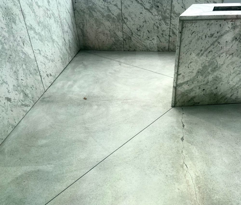 Black and white view of a turn in a marble walkway.