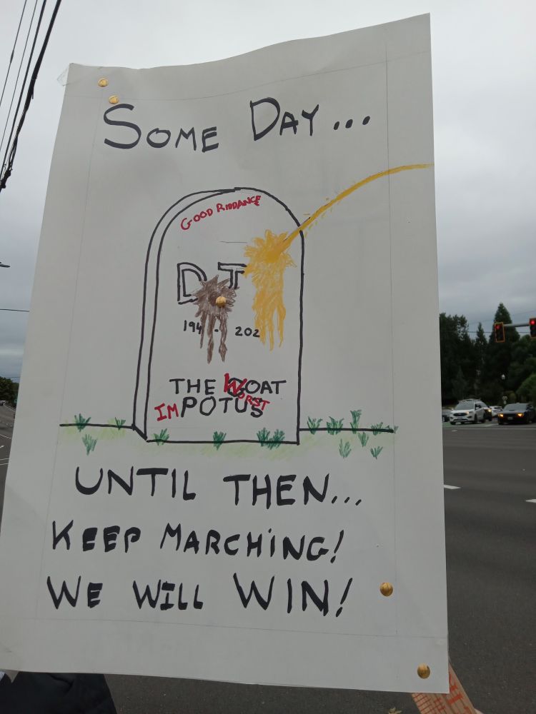 Protest sign. A picture of a tombstone getting hit with urine. Text: 