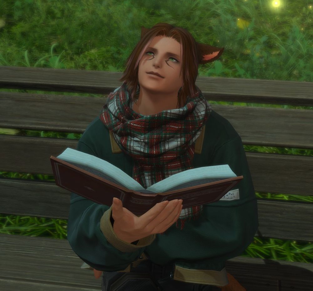 A Miqo'te wearing a comfortable jacket and scarf looks up at something while reading on a bench. He has a smile on his face as he looks up, as though contemplating something.