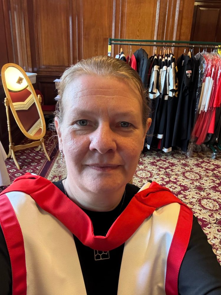 Me wearing my red and white academic dress prior to the ceremony. 