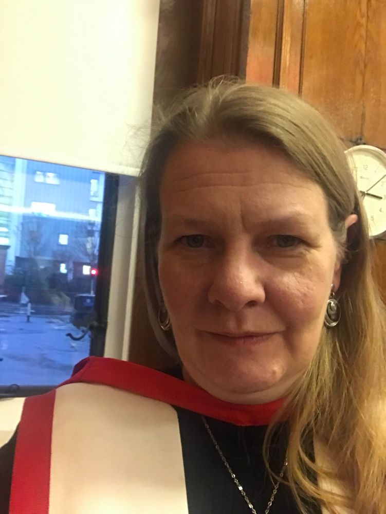 Me, selfie wearing academic gown at last year’s graduation.