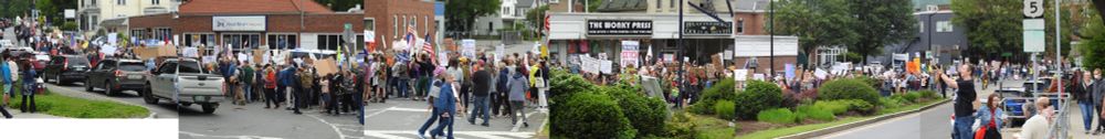 panorama of thousands of protestors marching on Main Street in Brattleboro from downtown to the common.