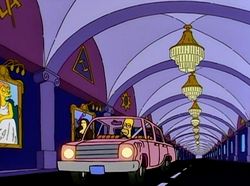 Homer Simpson drives through the Stonecutters' tunnel.