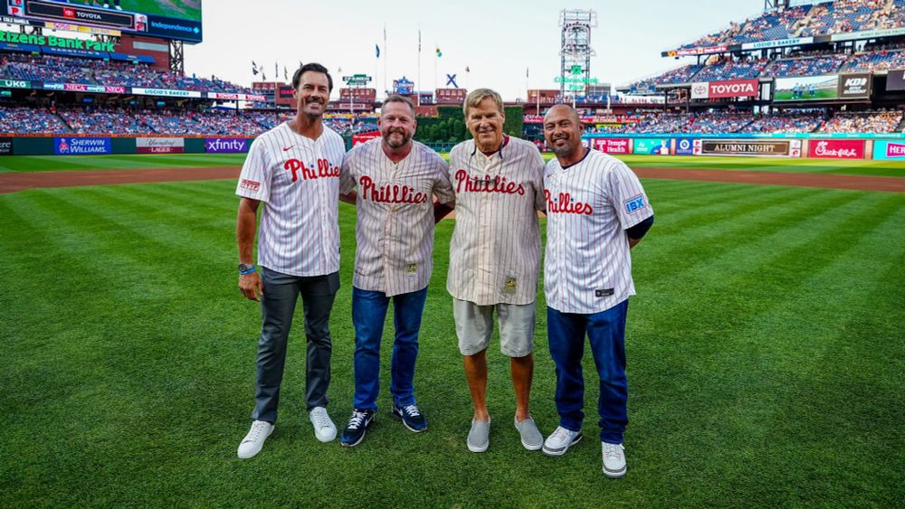 Cole Hamels and Shane Victorino pose with Chris Roberts and Richard Ashburn Jr. after tonight's ceremonial first pitch.