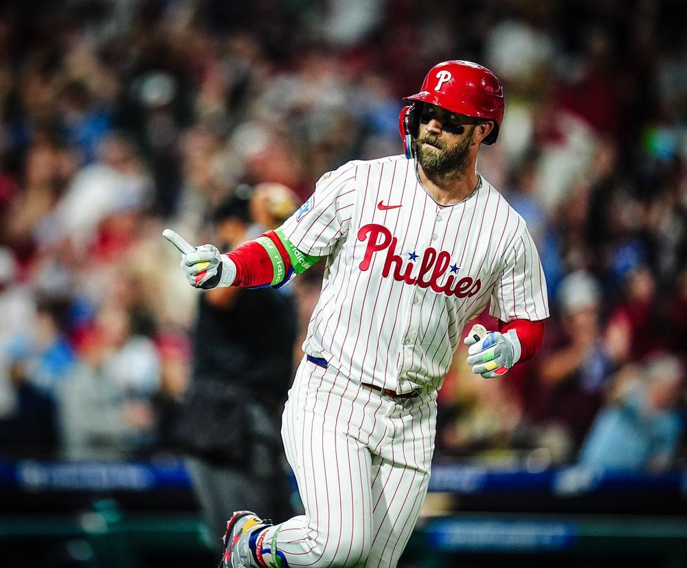 Bryce Harper celebrates after hitting his second home run of the night. He's wearing the pinstripes uniform