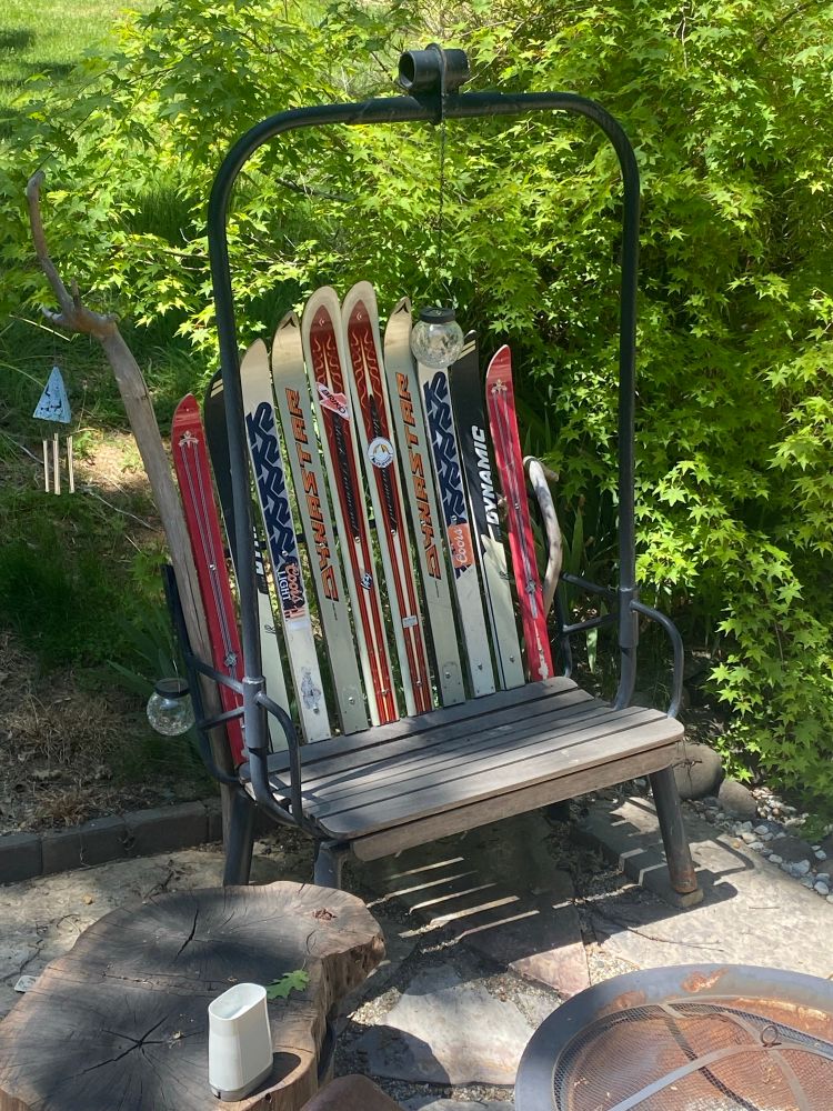 Bench style chair created for an old ski lift and using old skis for the back of the chair. 