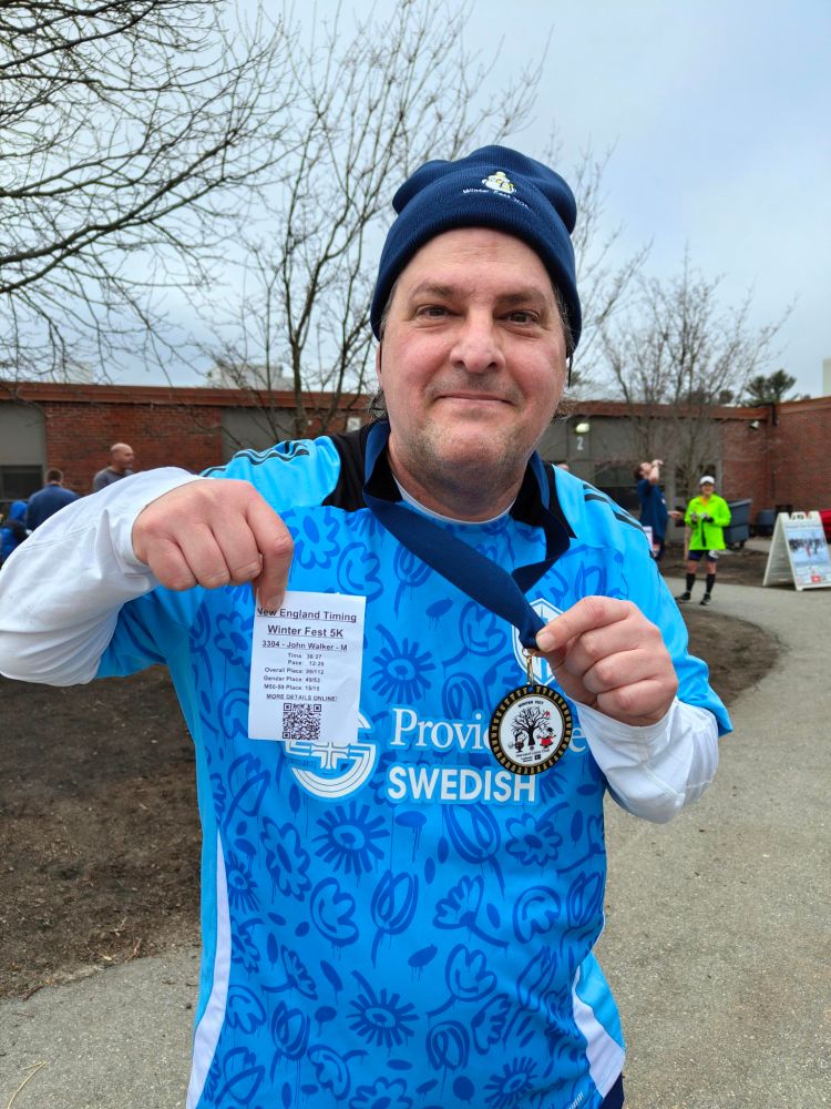 Me with my medal. I finished last among the 50+ runners lol