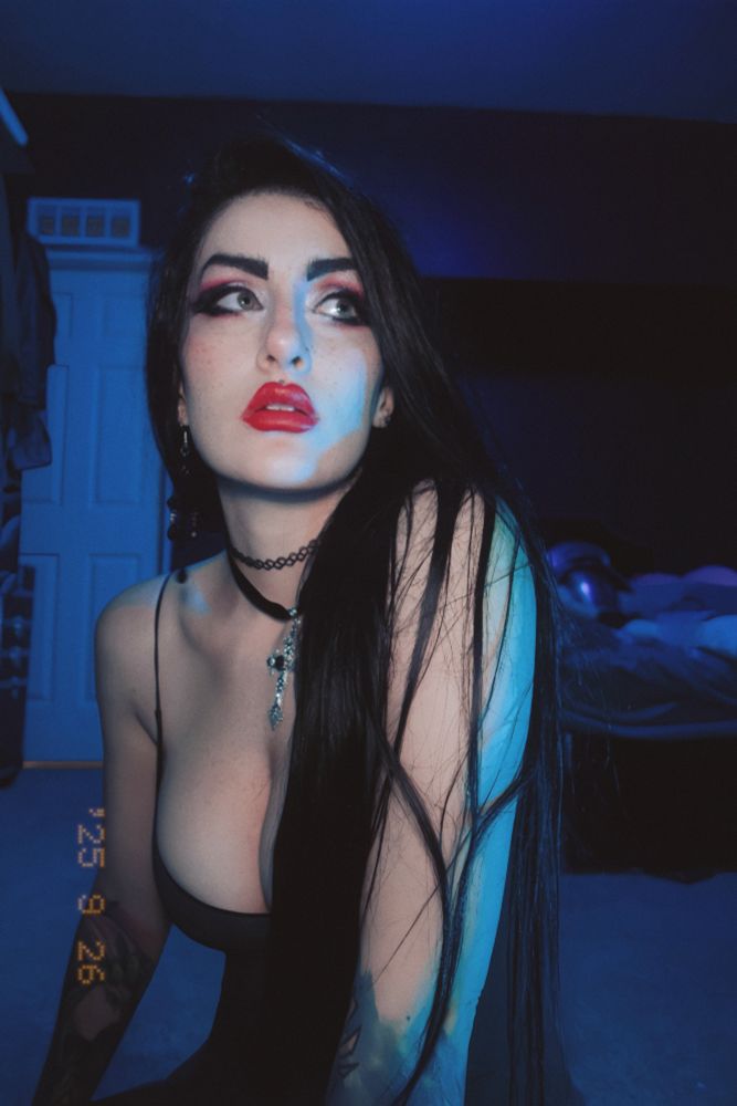 Pokket sitting on the ground, looking to the right (her left). 