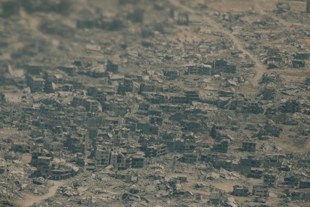 An aerial photograph of a completely devastated Gaza