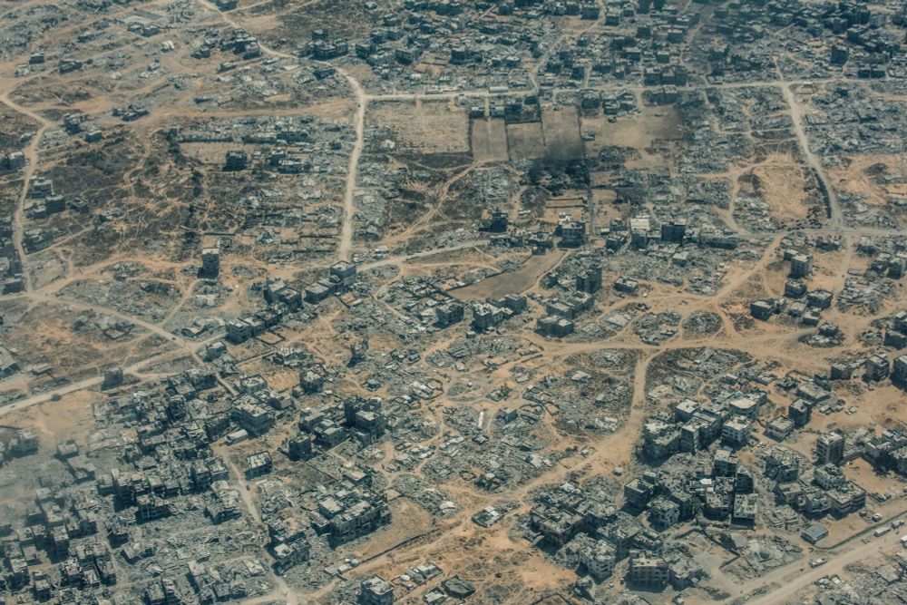 An aerial photograph of a completely devastated Gaza