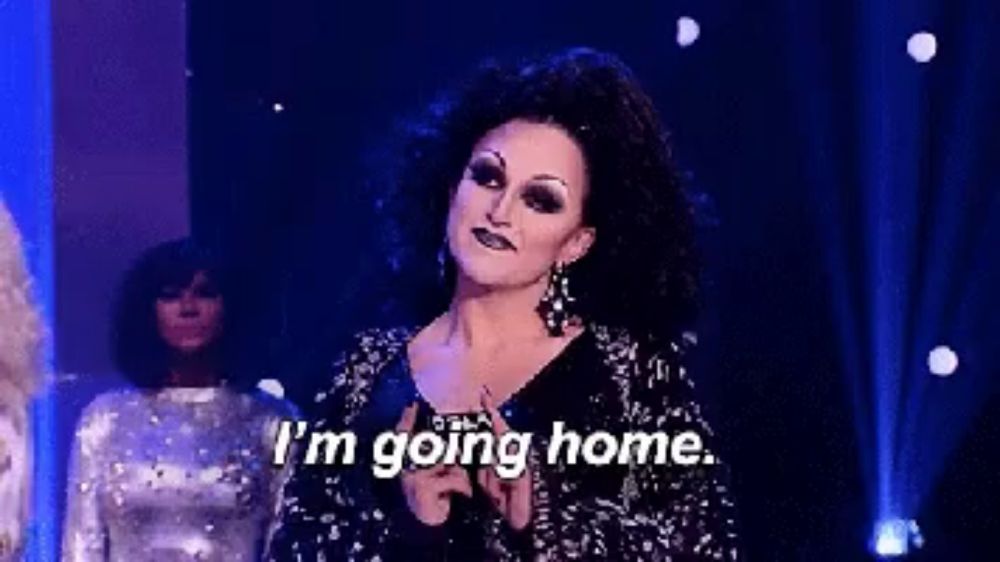 a drag queen says i 'm going home while holding a microphone