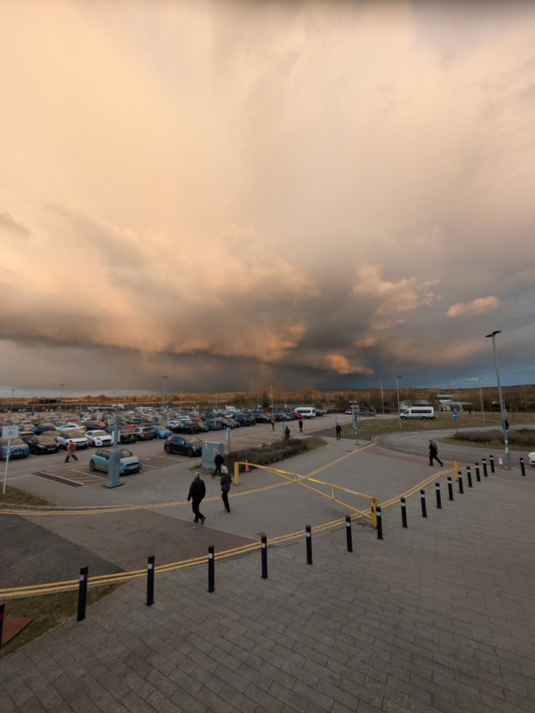 Car park with dramatic red and grey clouds