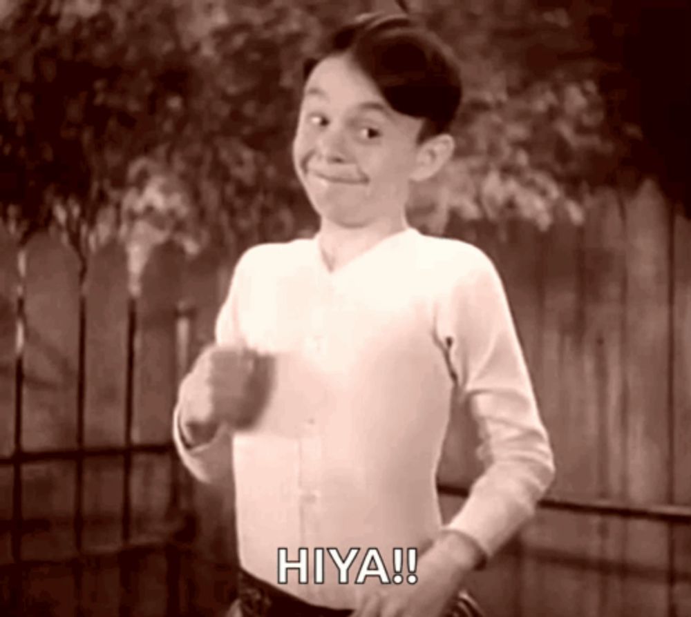 a black and white photo of a boy with the word hiya on his shirt