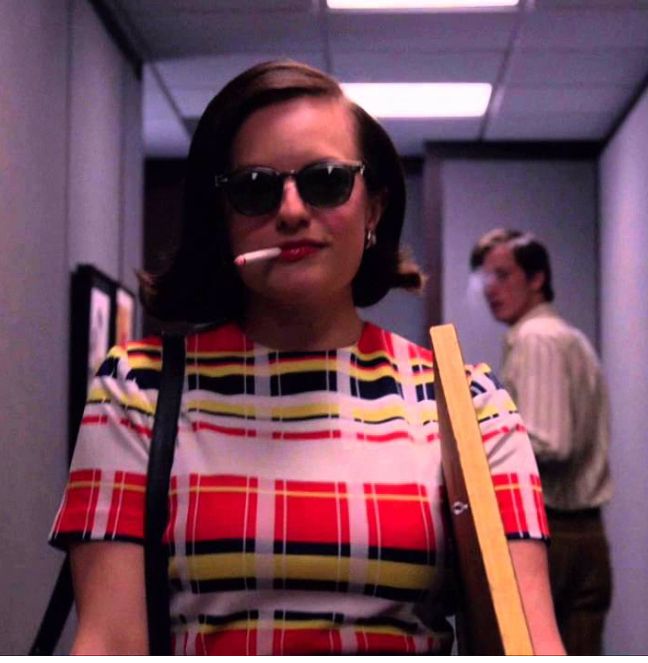 Peggy Olson from Mad Men, walking out with her box and her cigarette and her sunglasses.