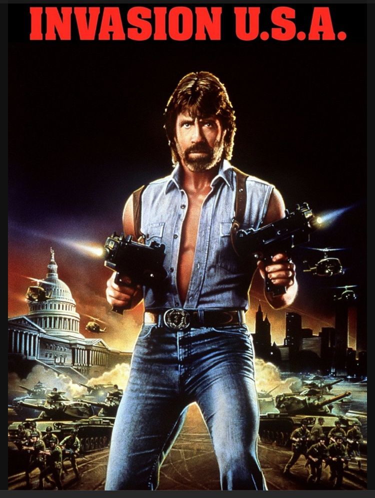 Poster: Invasion USA Chuck Norris firing two machine pistols at the viewer 