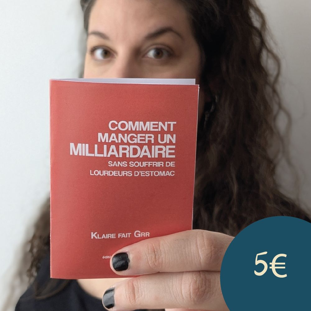 Un selfie où je tiens le prototype fait maison du livret (taille A7, soit une carte postale pliée en deux) 