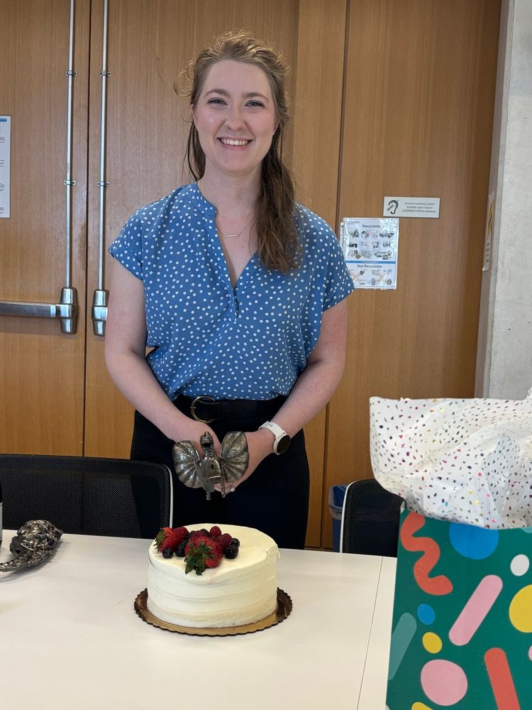 Emily posing with the Dragon Knife about to cut a celebratory cake 
