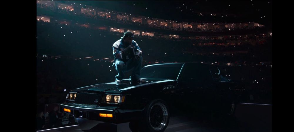 Kendrick Lamar performing on top of a car during the half time show at the Superbowl February 9, 2025. Superbowl LIX 