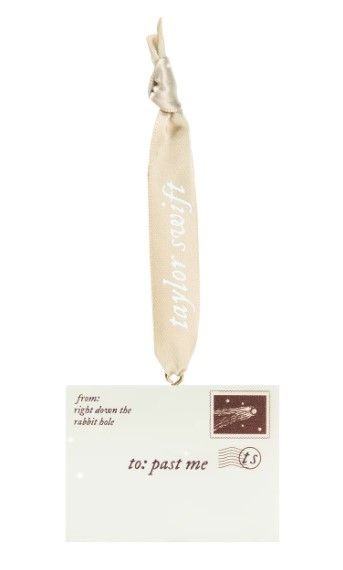 down the rabbit hole envelope ornament. an envelope with "from: right down the rabbit hole." and "to: past me" with a ts stamp and a ribbon with taylor swift on it.