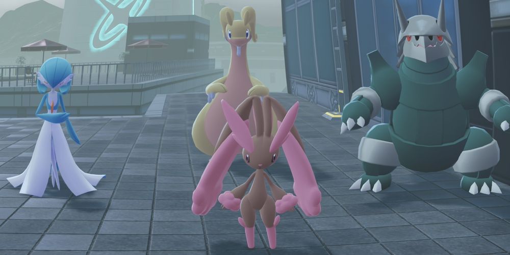 back row left to right: shiny Gardevoir, shiny Goodra, shiny Aggron. 

front row: shiny Lopunny.

Gardevoir is blue and white with the white resembling a ball gown. 

Goodra is a large yellow dragon.

Aggron is a large green steel dinosaur pokémon.

Lopunny is a brown bunny with pink accents on her ears, feet, hands, and eyebrows.