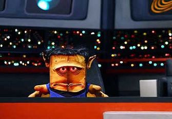 The German children’s tv character Bernd das Brot (Bernd the bread) a loaf of bread.
Bernd wears a blue Star Trek uniform on the bridge of the TOS Enterprise