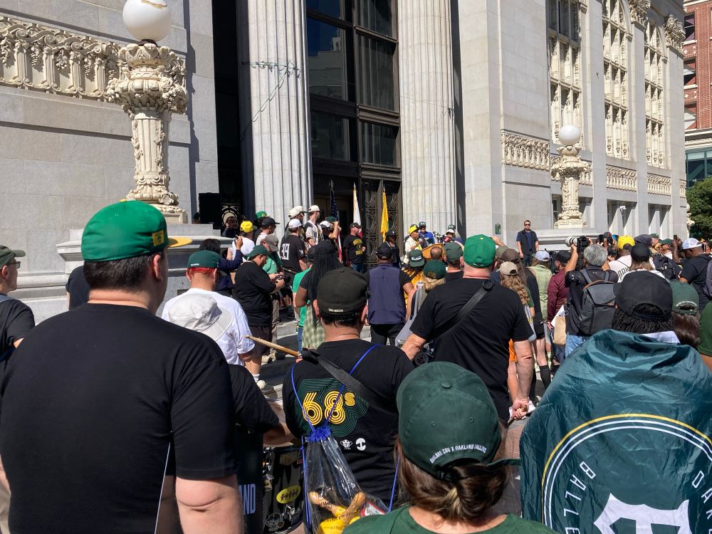 A crowd of fans outside Oakland City Hall with Mayor Barbara Lee at the podium