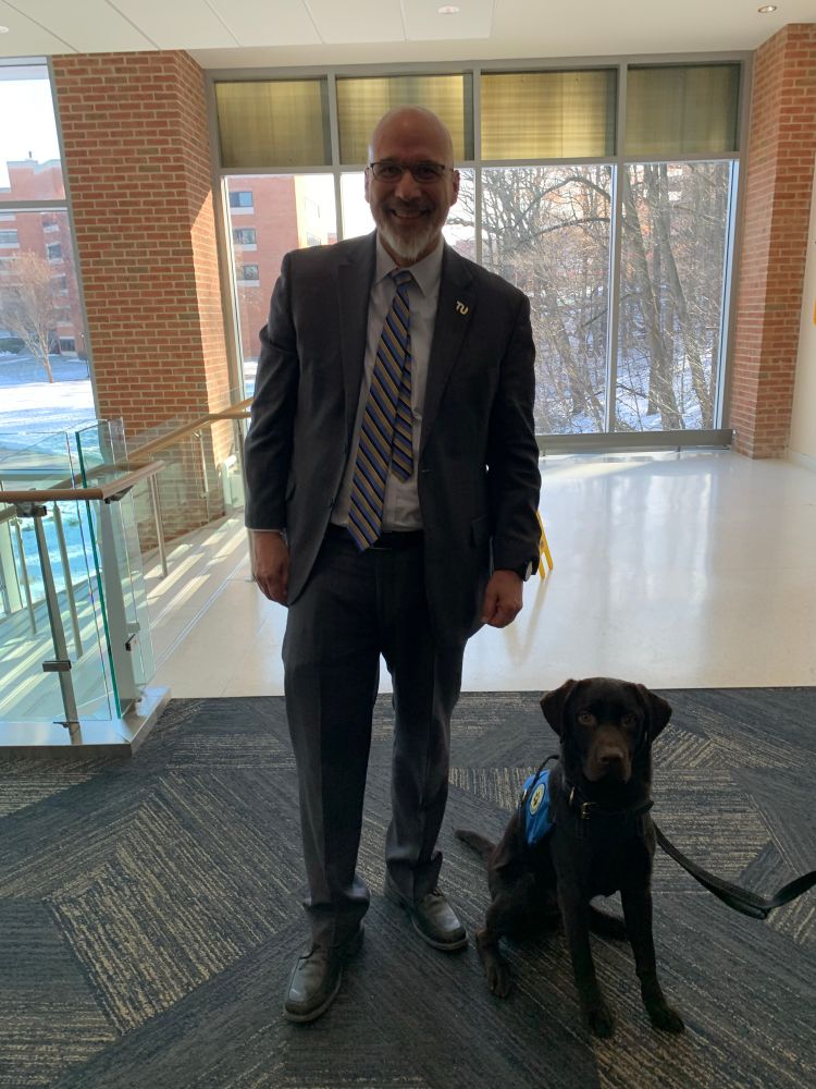 Man posing with a dog. 
