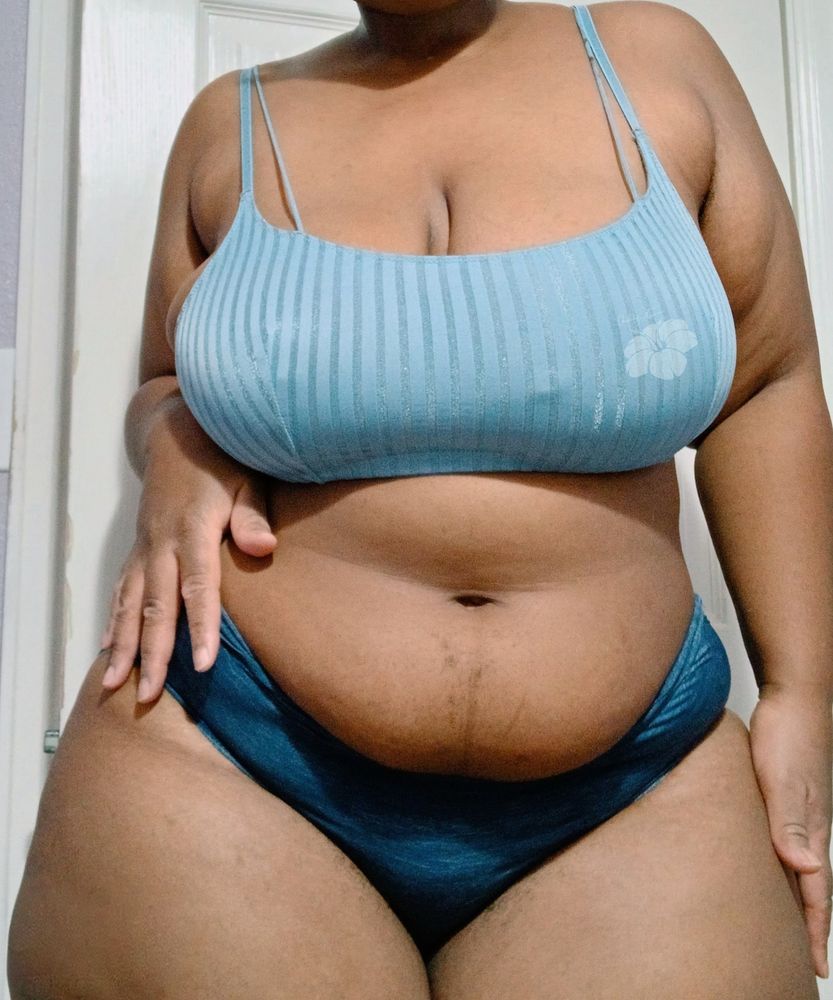 Mauve stands in front of a white door wearing a light blue bra and dark blue panties. Her hand is placed on her hip and the other on her thigh.

#bbw #NsfwSky #SpicySky 
