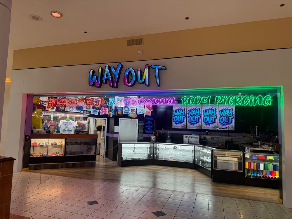 A mall store that advertises airbrushing and professional body piercing in the same store.
