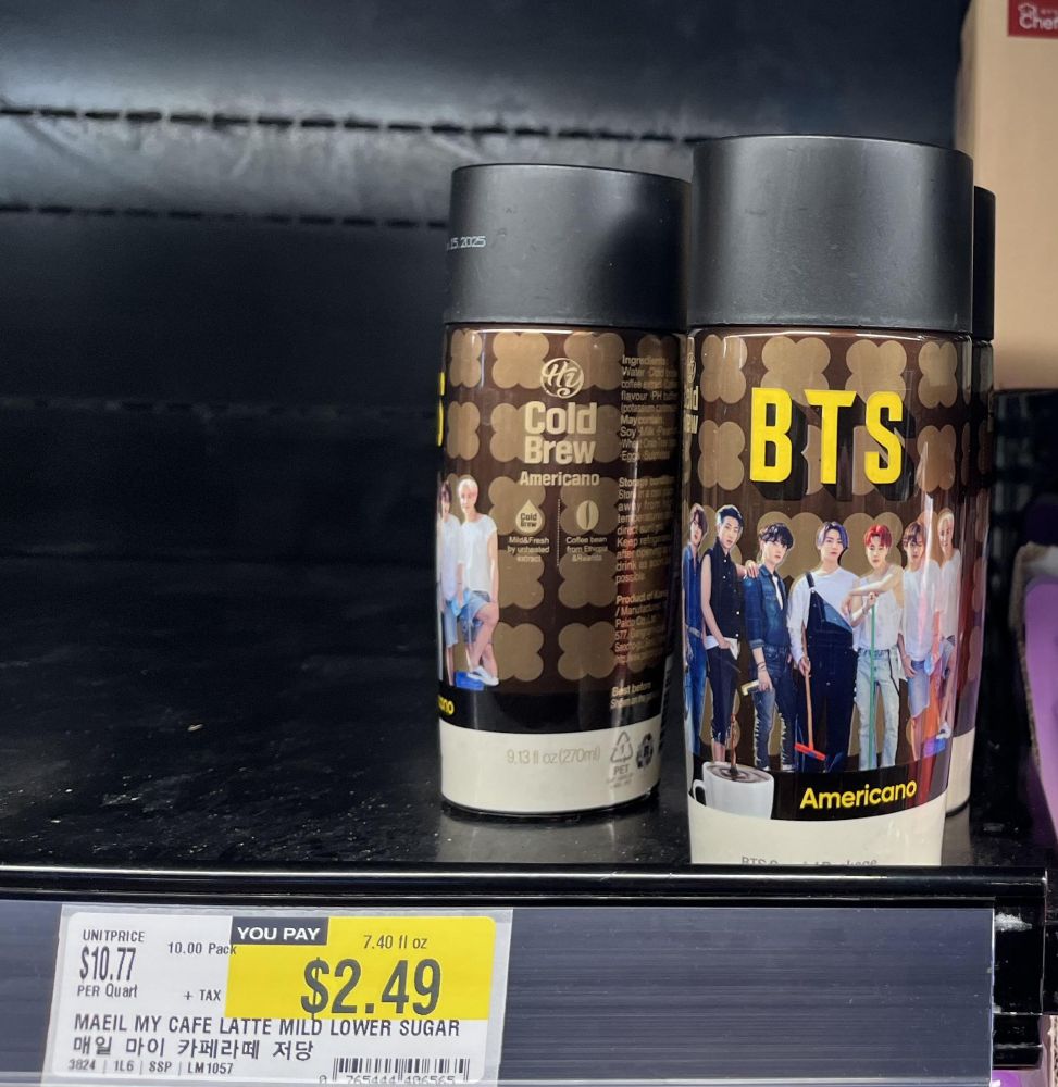 Several bottles of BTS branded coffee on a store shelf.