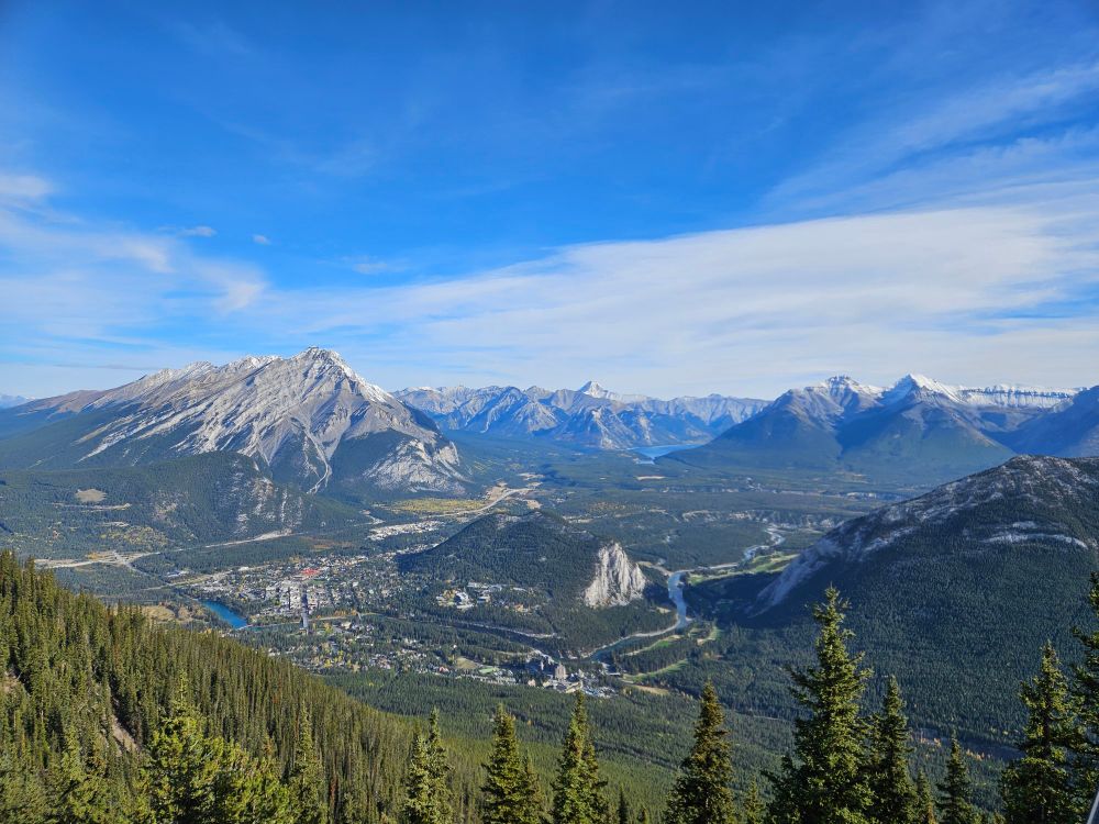 Aerial view of Banff from the Banff Gondola. Blue sky and snow capped mountains. 