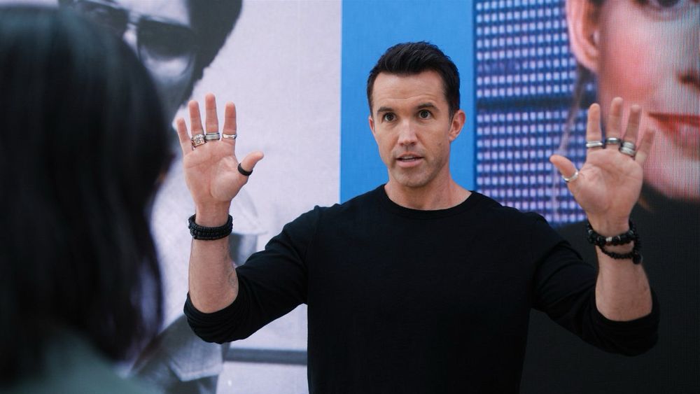 The character Ian from Mythic Quest is pictured wearing rings on every finger and a lot of bracelets, typical of lesbian fashion.