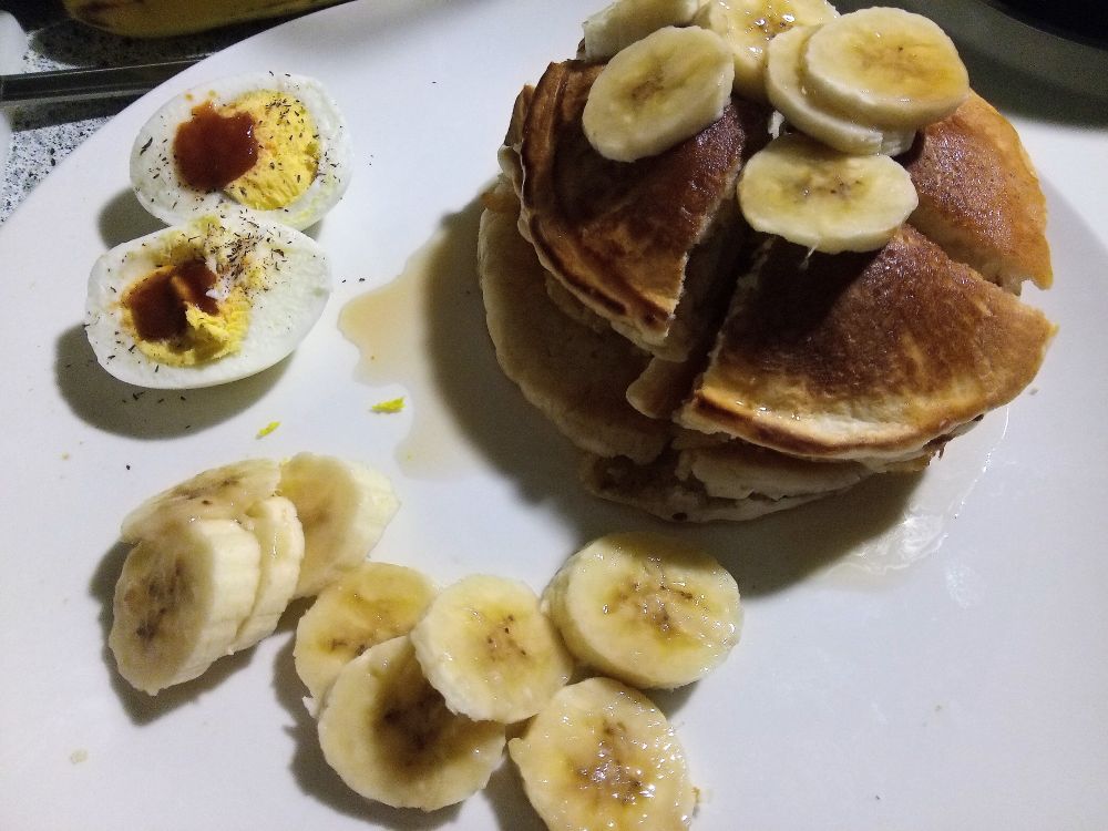 A handsome artist makes pancakes.