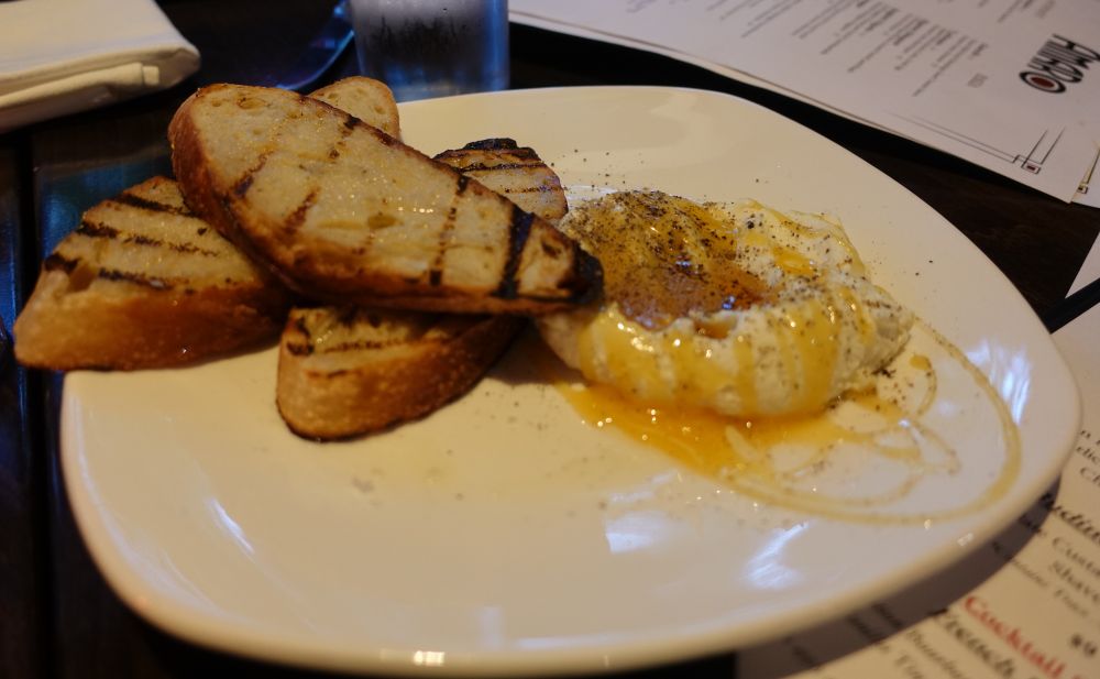 Ricotta al Tartufo, which is whipped ricotta, truffle infused chestnut honey, cracked pepper and grilled bread.