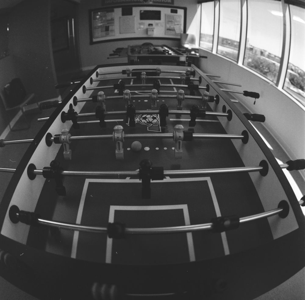 A wide angle photo of a foosball table. 