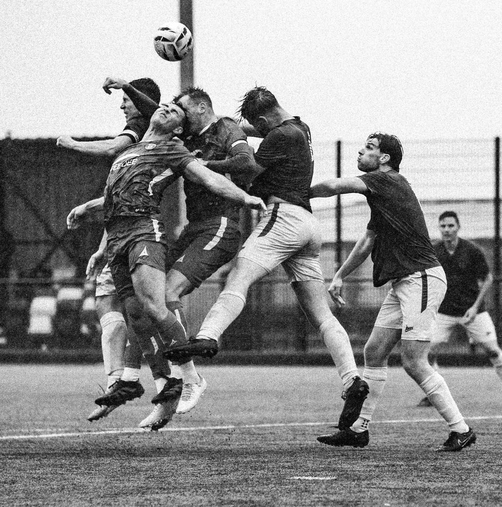 5 football players contesting a high ball