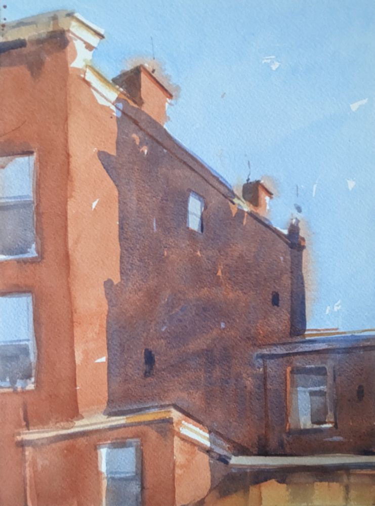 Watercolor painting of the side of an apartment building. The red brick building is mostly covered in a large dark purple shadow from a building to the right and out of frame blocking the bright sunlight. A single paned window reflects back the blue sky.