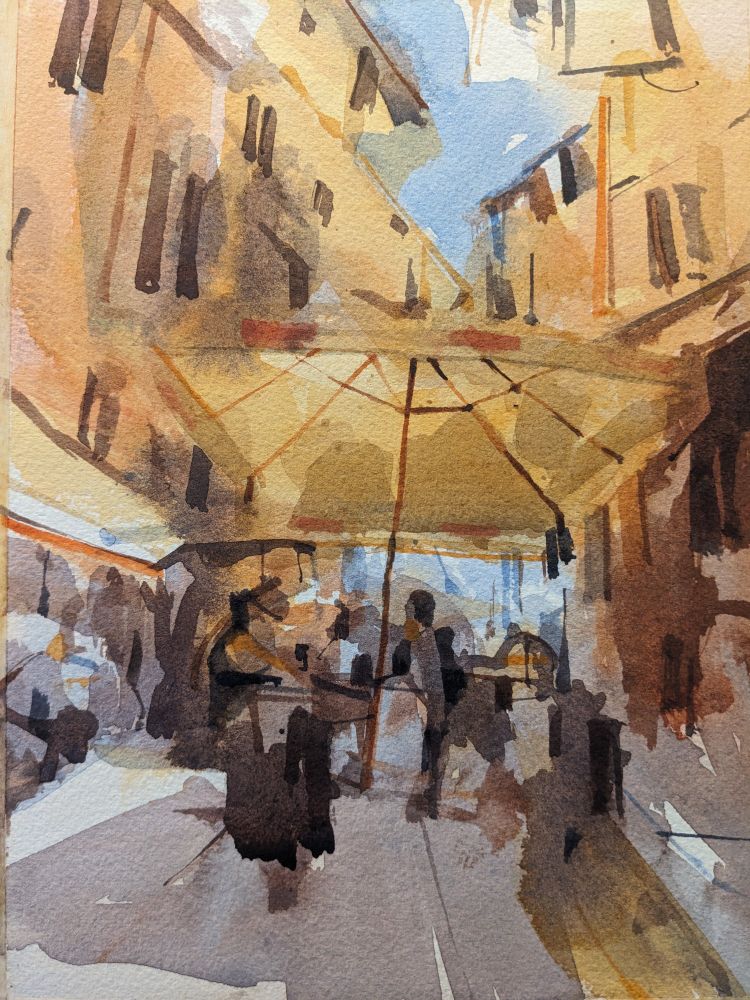 Watercolor painting of a street market in Palermo, Sicily. A large, cream colored umbrella is seen from the underside as it takes up the width of the narrow cobbled street in downtown Palermo. The vendor stall, covered in dark shadows draping indescript people, is set on the street between two ochre buildings with tall thin windows dappled across their multiple stories. A small keyhole of blue sky peeks out in the upper middle of the scene while light floods the buildings and casts a long purple shadow down the street toward the viewer.