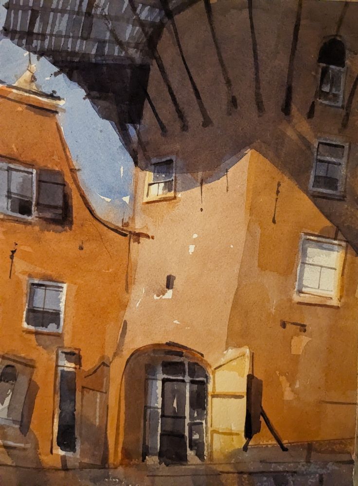 Watercolor painting of Molen de Roos in Delft, Netherlands. The lower portion of the windmill is seen on the right, a large purple shadow being cast from its wooden plank stage. A series of windows runs vertically on the right side of the windmill while an entrance with opened, wooden doors appears on the left side. A building with a swooping facade abuts against the windmill, with windows of varying sizes.
