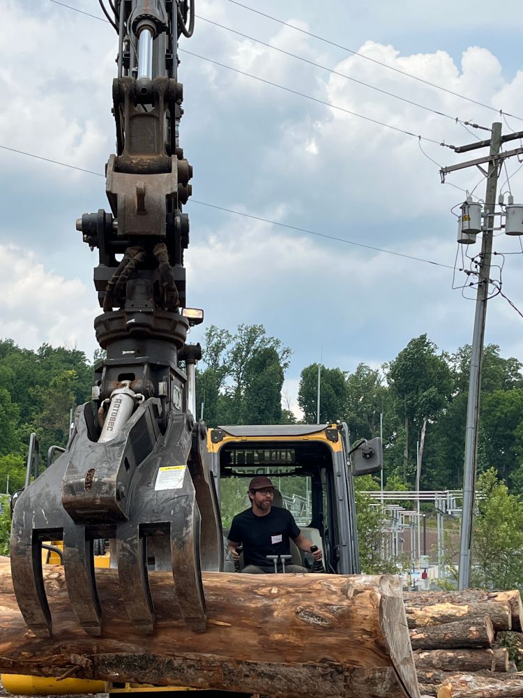 A tree log being moved by heavy equipment at Baltimore's Camp Small.
