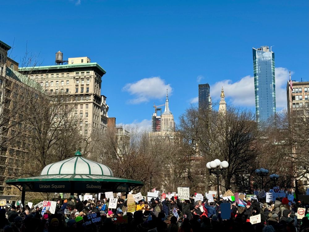 a beautiful sunny day in New York City’s Union Square Park, filled with peaceful protesters