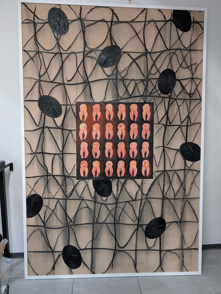 A large painting with what look like sperm cells surrounding a grid of laid out human teeth.