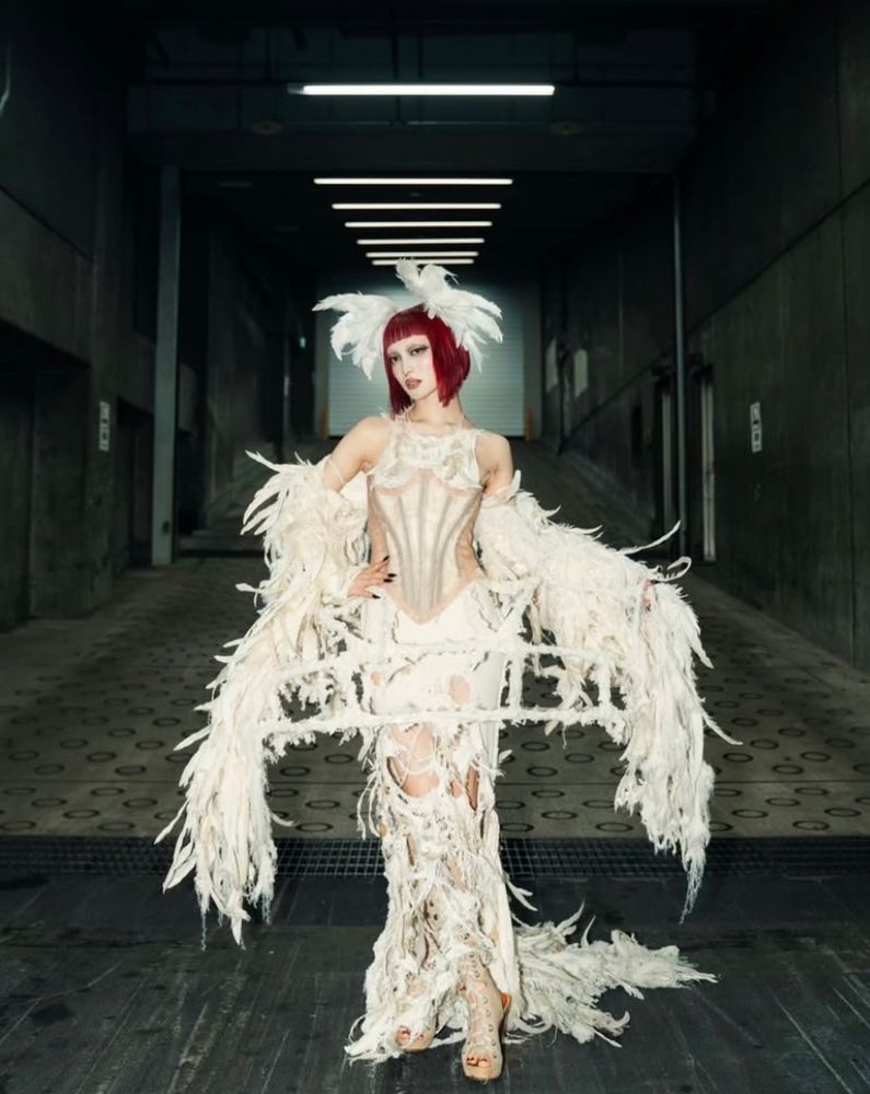 jurin from xg posing in a feathered gown