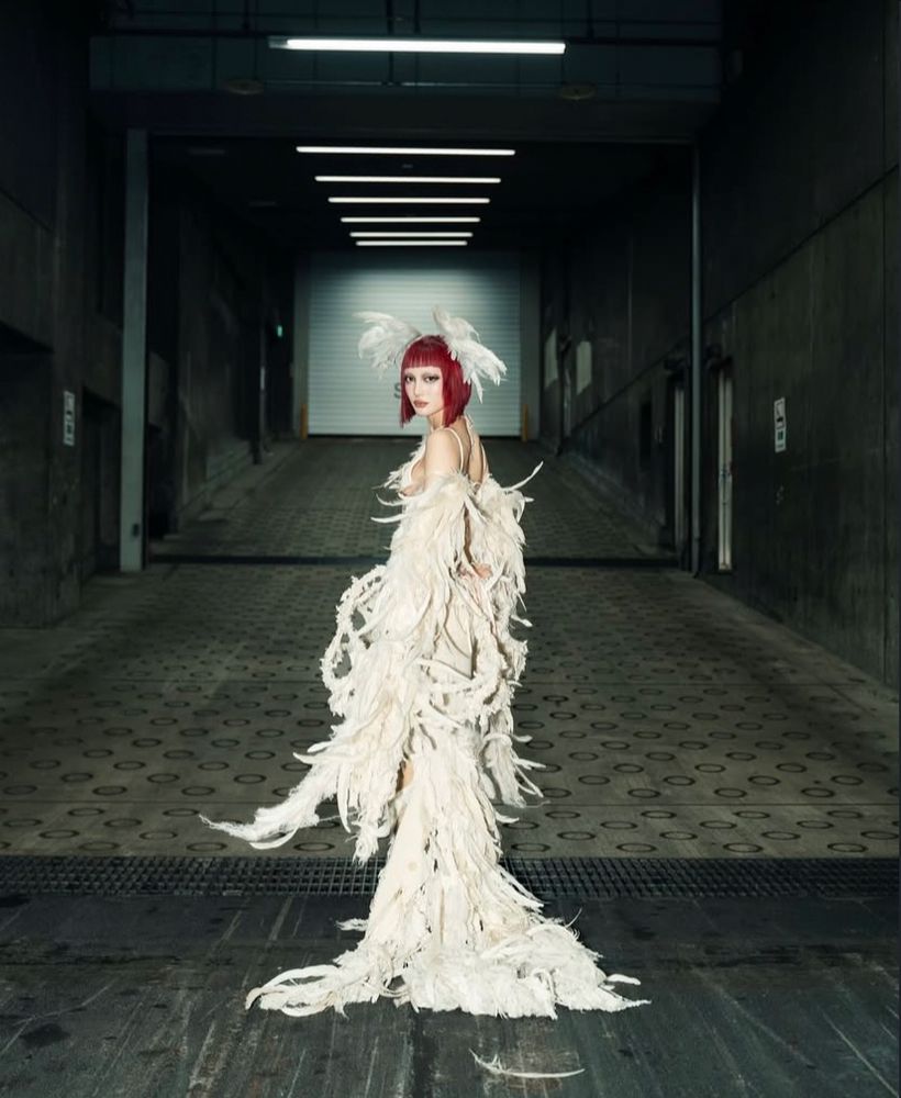 jurin from xg posing in a feathered gown