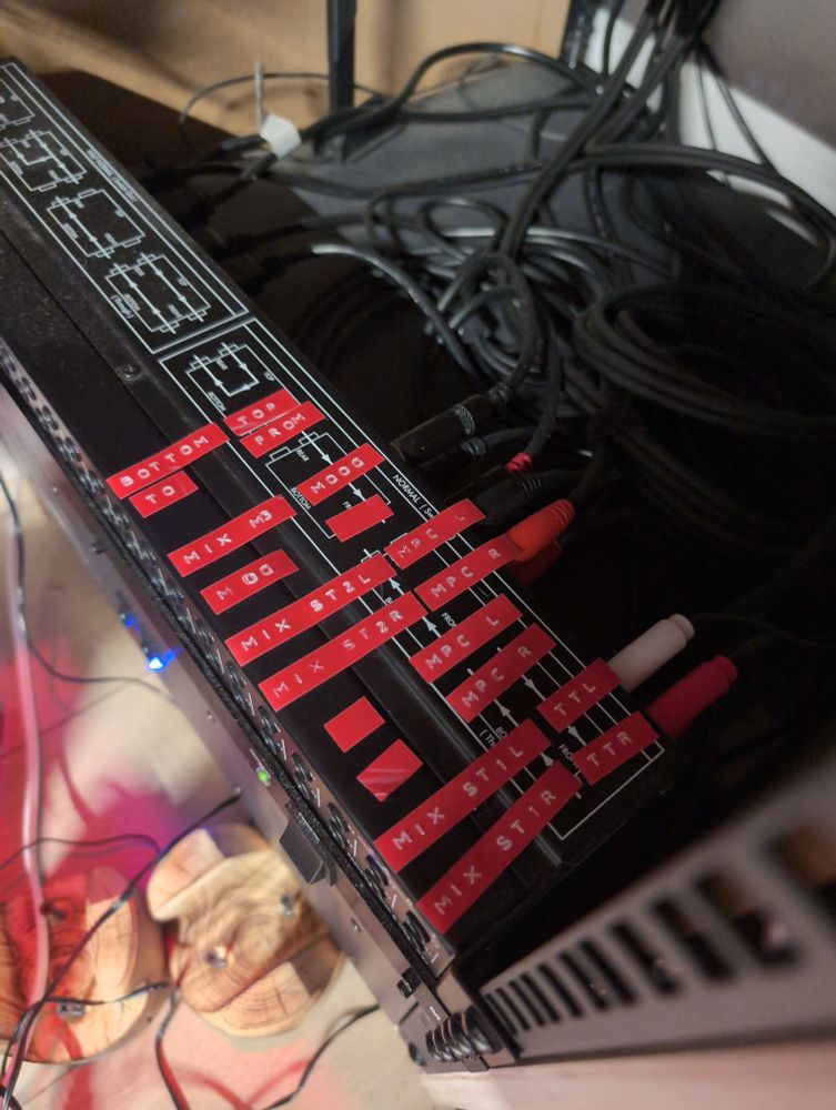 Top of a patch bay with labels showing what's plugged into what