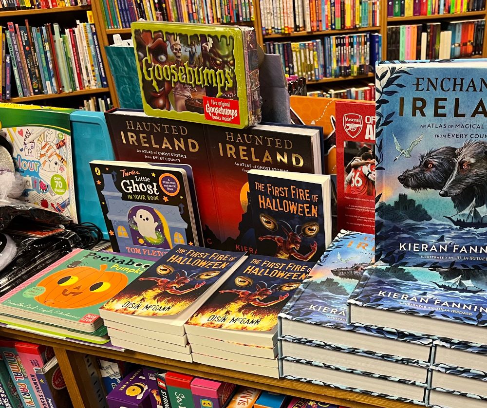 The First Fire of Halloween stacked on a Halloween display of similarly themed books in the shop.