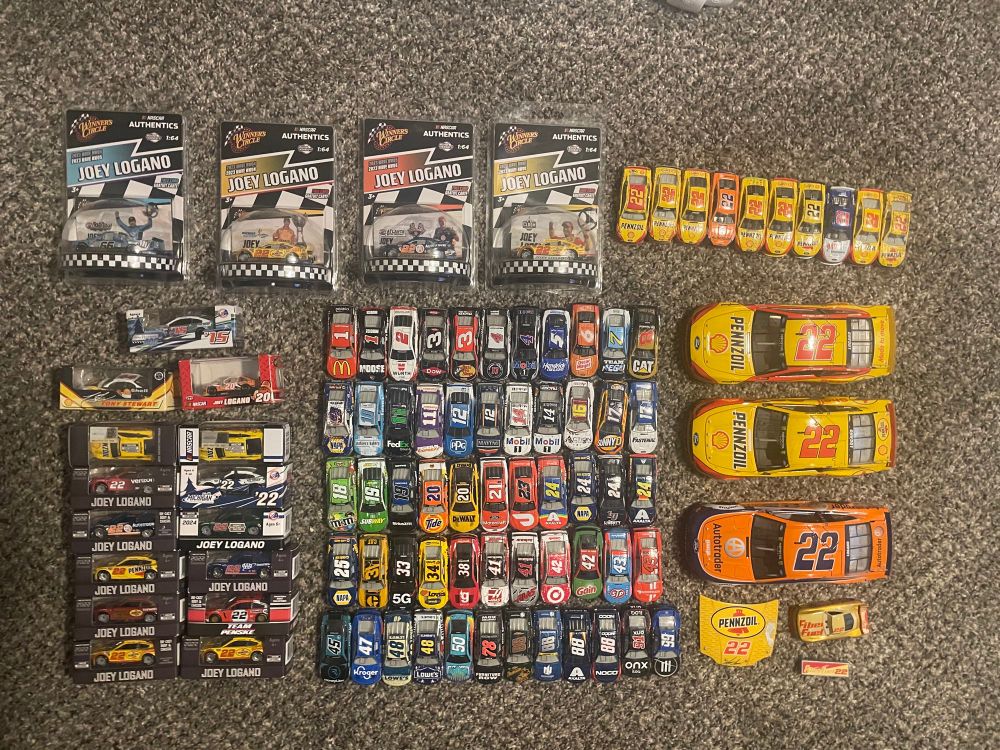 All of my NASCAR diecasts! The center includes five rows of 1:64s sorted by number. To the left is six pairs of boxed Logano 1:64s, and above those are 4 boxed Winner’s Circle diecasts. In the top right are ten unboxed Logano 1:64s, with three of his 1:24s below those. 